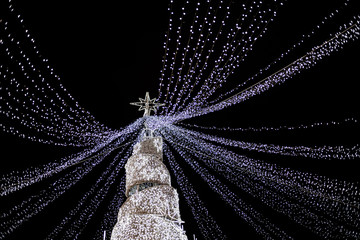Modern glowing Christmas tree on black background.
