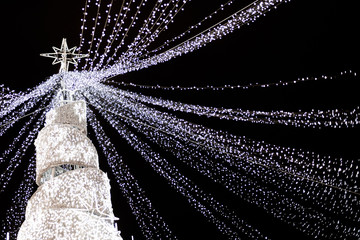 Modern glowing Christmas tree on black background.