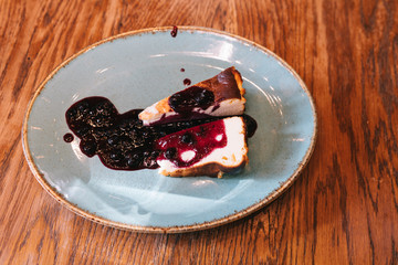 two slice of San Sebastian Cheesecake with green plate. Burnt basque cheesecake