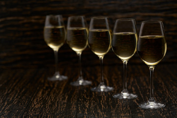 white wine on a black wooden background, close up.