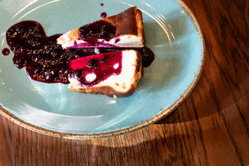 two slice of San Sebastian Cheesecake with green plate. Burnt basque cheesecake