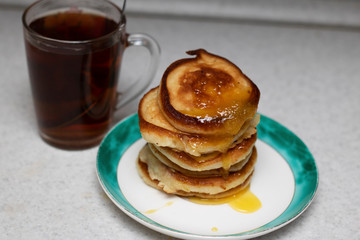 pancakes with honey and cup of tea