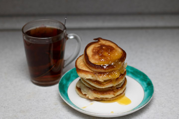 pancakes with honey and cup of tea