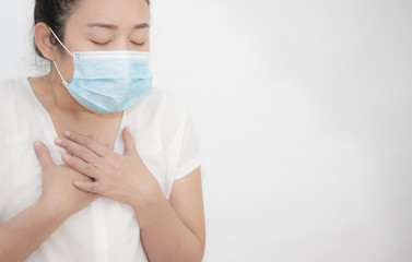 The image of a young Asian woman wearing a mask to prevent germs, toxic fumes, and dust. Prevention of bacterial infection in the air in a white background