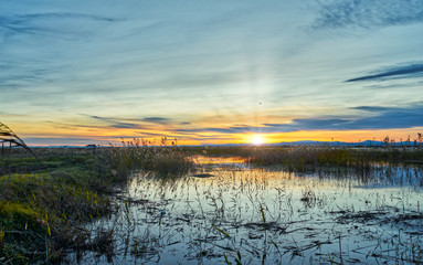 Sunset in the calm waters of the Albufera de Valencia, Spain.