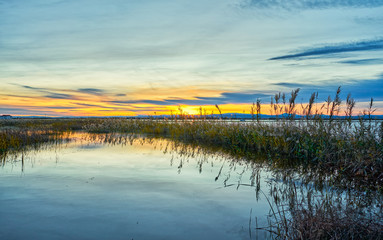 Sunset in the calm waters of the Albufera de Valencia, Spain.