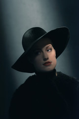 Retro 1940s woman in black hat.