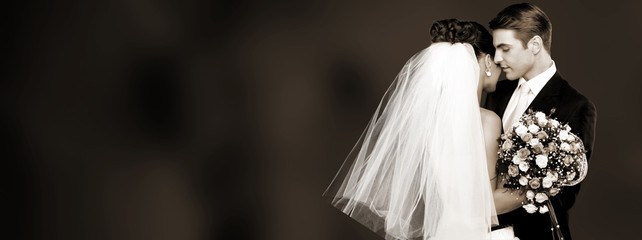 Happy just married young couple on black background
