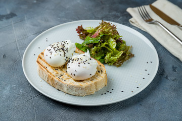 toast with poached egg on grey table