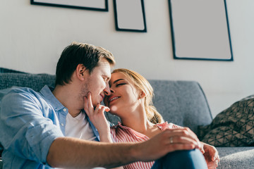 Cheerful couple hugging sitting on floor