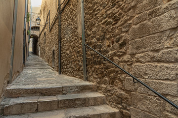 Narrow medieval street with arch in Girona. Girona's typical narrow street, medieval village in Northern Catalonia