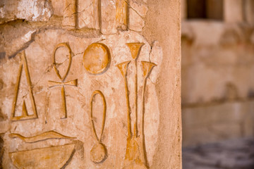 Relief details and Egyptian hieroglyphs at the Mortuary Temple of Hatshepsut in Luxor, Egypt