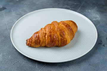 The classic croissant on grey table