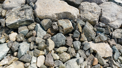 Close up to stones and rocks grey color shot at the bright day