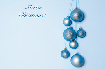 New Year card, banner, blank with bright balls on a blue background with a wish of a merry Christmas. copy space, text, layout, postcard, poster