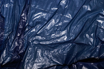 Abstract texture of black crumpled polyethylene for recycling, the concept of garbage, ecology,...