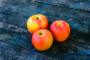 Pile of the ripe apples on wooden table
