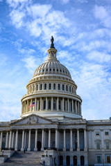 East side of the US Capital with flag at half staff and blue sky