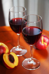 Two glasses with red wine with peaches	