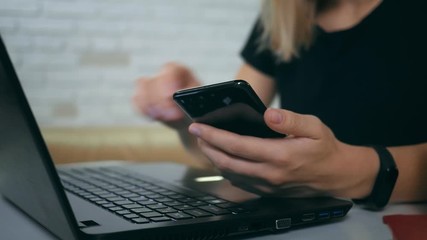 Two-factor authentication. Progressive verification of the technology used. Young woman entering a security code to access their bank account or personal data online.