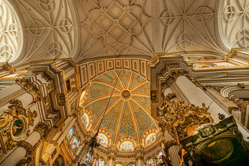 Obraz premium Magnificent golden dome inside the Granada Cathedral in Spain. Interior decoration found in the Granada Royal Cathedral