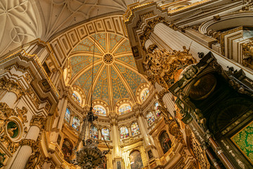 Obraz premium Magnificent golden dome inside the Granada Cathedral in Spain. Interior decoration found in the Granada Royal Cathedral