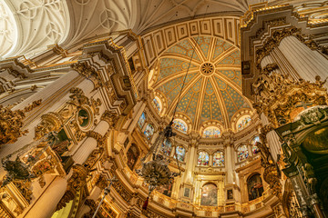 Fototapeta na wymiar Magnificent golden dome inside the Granada Cathedral in Spain. Interior decoration found in the Granada Royal Cathedral