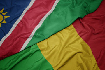 waving colorful flag of mali and national flag of namibia.