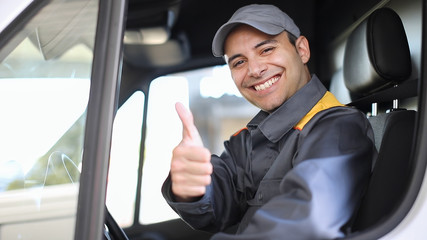 Smiling van driver portrait giving thumbs up