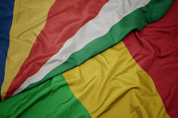 waving colorful flag of mali and national flag of seychelles.