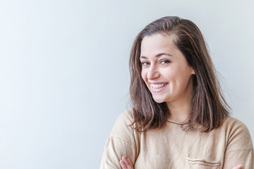 Obraz premium Happy girl smiling. Beauty portrait young happy positive laughing brunette woman on white background isolated. European woman. Positive human emotion facial expression body language