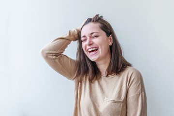 Happy girl smiling. Beauty portrait young happy positive laughing brunette woman on white background isolated. European woman. Positive human emotion facial expression body language