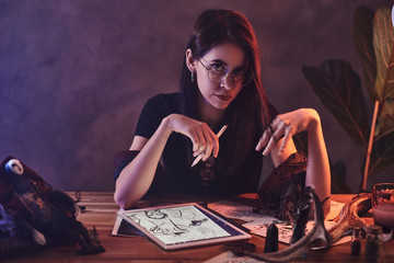 Young attractive girl is working on her new project with puppets.