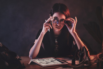 Young attractive girl is working on her new project with puppets.