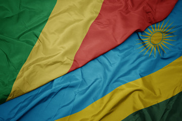 waving colorful flag of rwanda and national flag of republic of the congo.