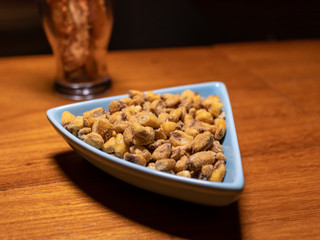 Salted toasted corn snacks in ceramic pot on wooden table, Rio de Janeiro, Brazil