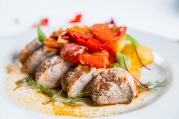 Roasted pork fillet with vegetables on a plate