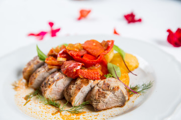 Roasted pork fillet with vegetables on a plate