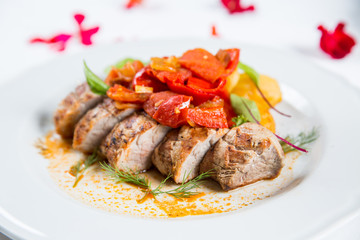 Roasted pork fillet with vegetables on a plate