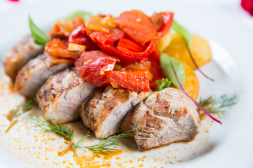 Roasted pork fillet with vegetables on a plate
