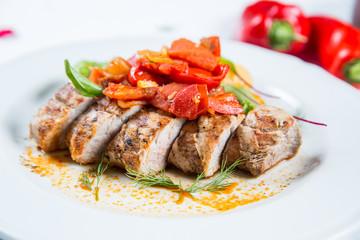 Roasted pork fillet with vegetables on a plate