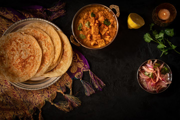 Indian cottage cheese with flat breads served in copper bowl