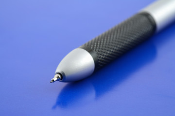 Black pencil isolated on blue background