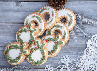 Christmas cookies decorated with royal icing on wooden table