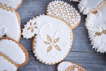 Christmas cookies decorated with royal icing on wooden table