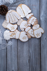 Christmas cookies decorated with royal icing on wooden table