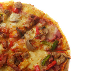 Pizza in round shape, topped with meat, ham, mushroom and veggies