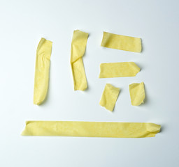 set of various pieces of yellow sticky paper tape on a white background