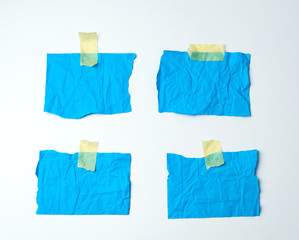empty blue crumpled pieces of paper glued with duct tape