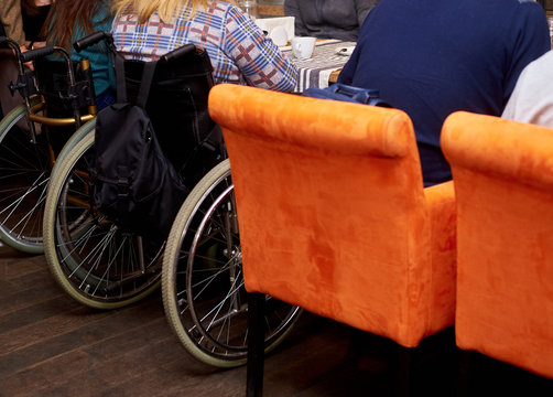 unrecognizable man in wheelchair in cafe